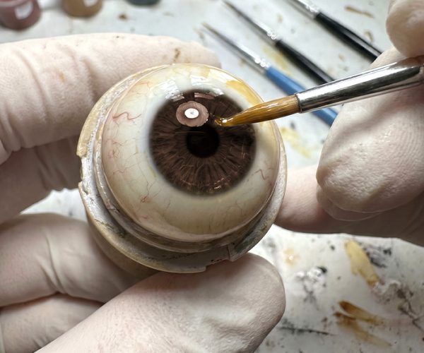 Layered coloring technique for a natural-looking ocular prosthesis